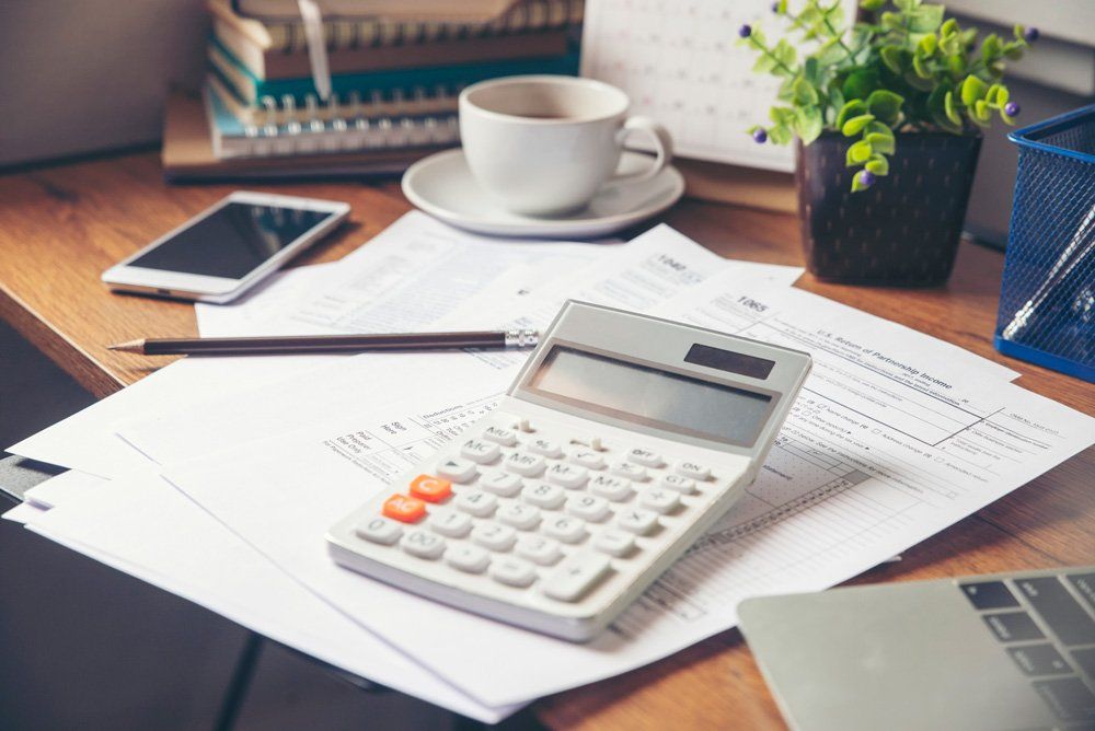 White Calculator on the Table — Perth, WA — Owen & Plaistowe