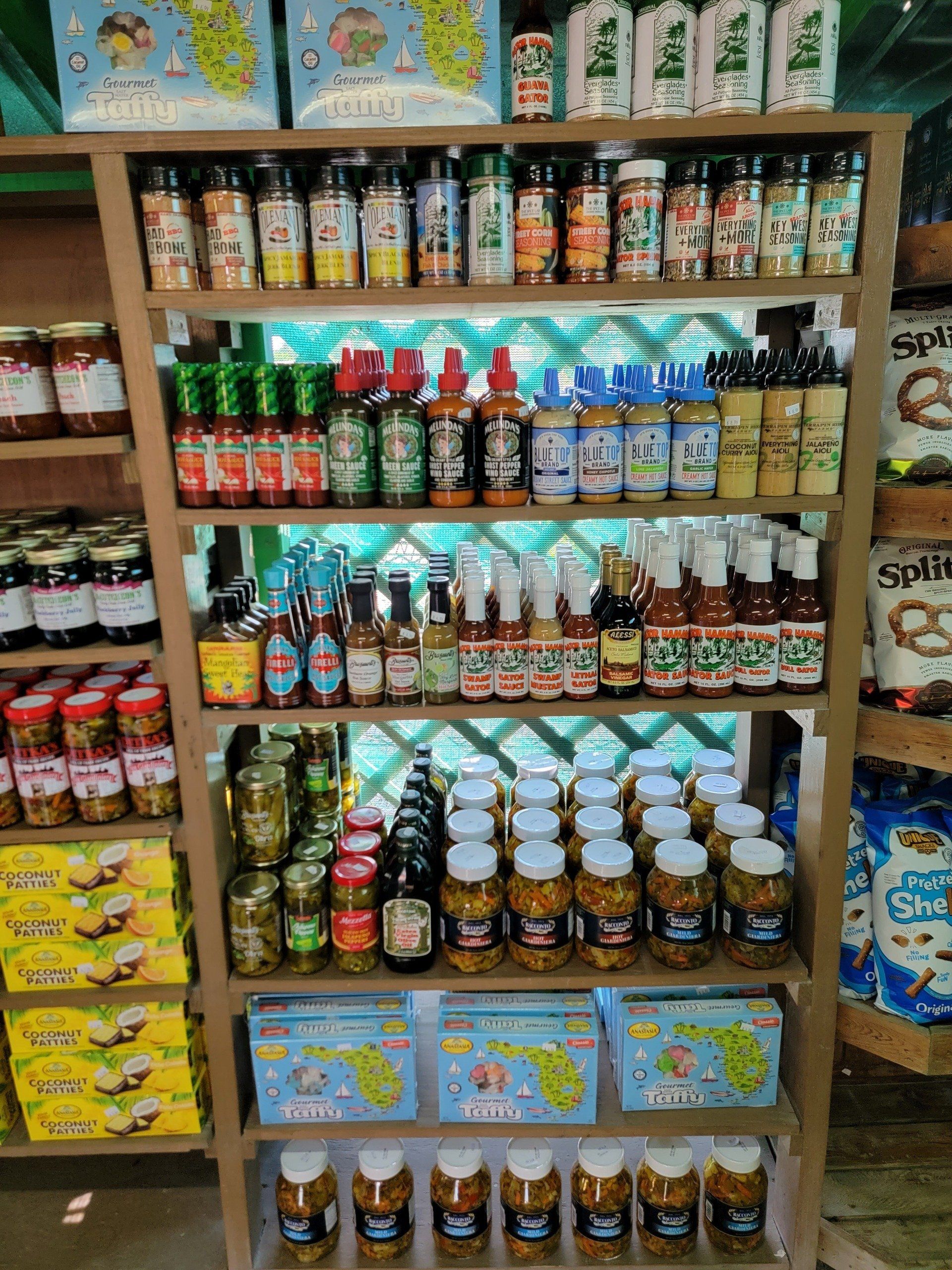 Shelves stocked with various jars of pickled foods, sauces, and spices.