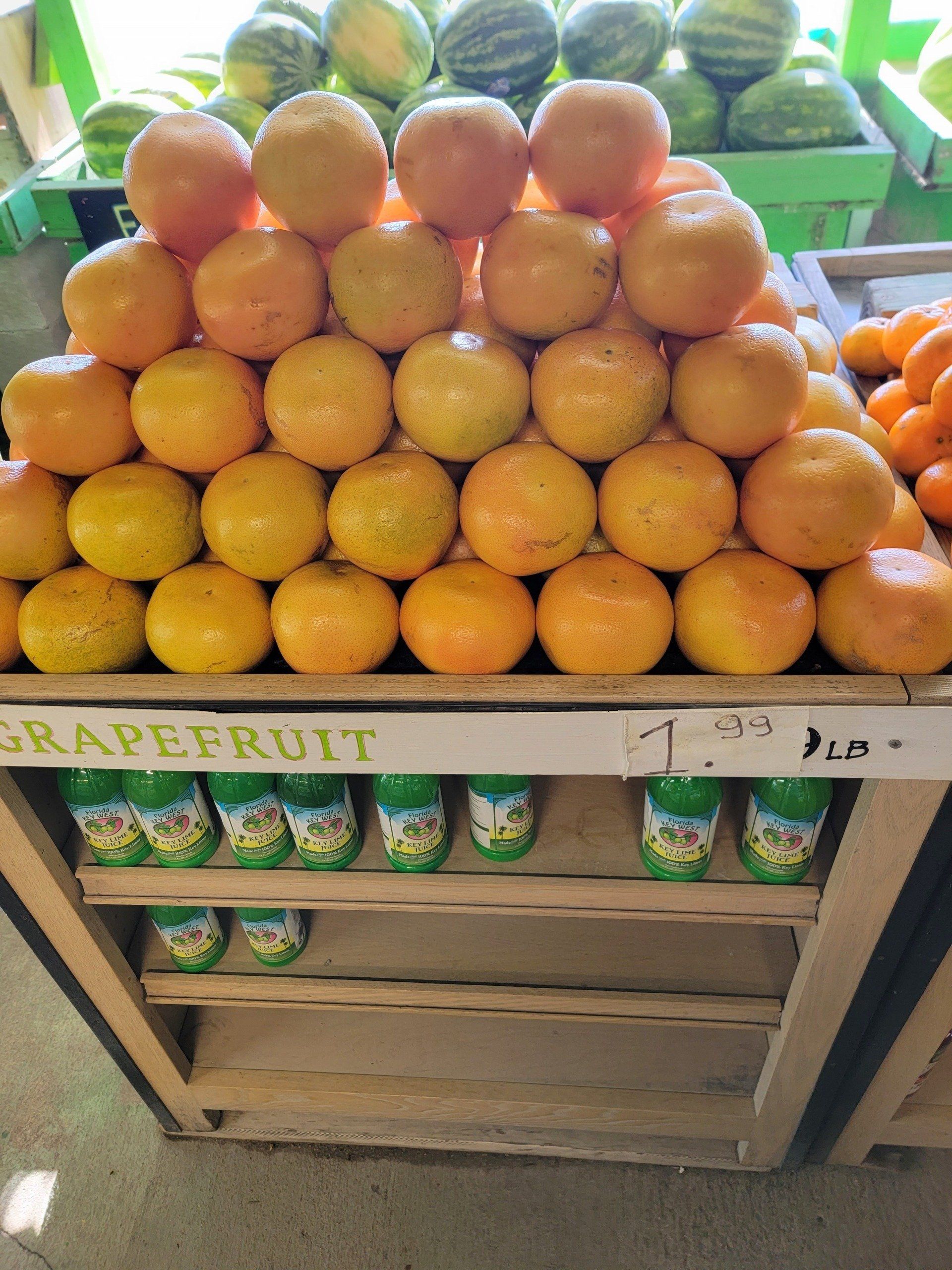 Pyramid of grapefruits for sale, with a price tag of $1.99 per pound.