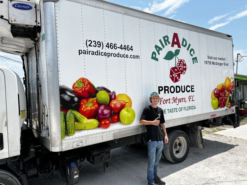 Man stands beside a truck with