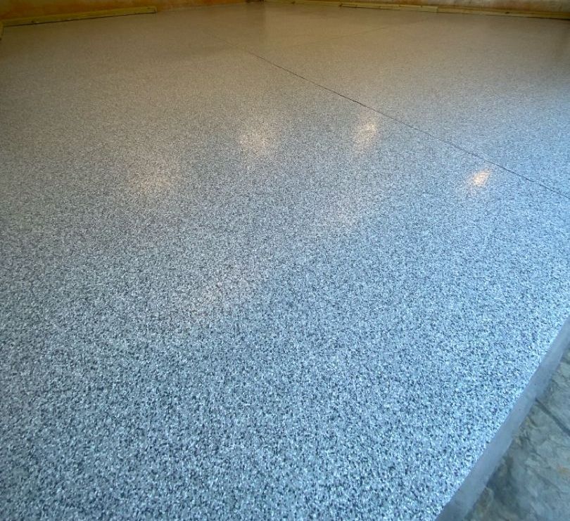 a close up of a gray marble floor in a room .