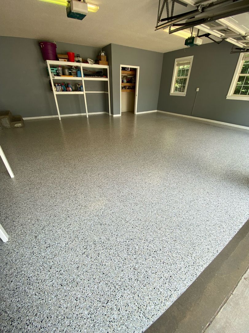 a garage with a gray floor and gray walls .