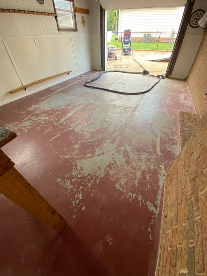 a garage with a red floor and a white wall .