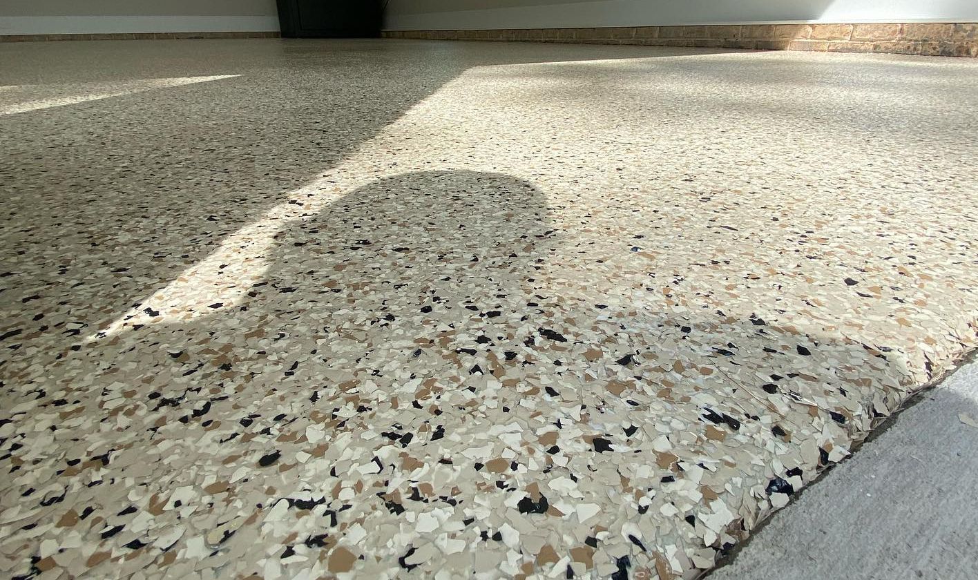a close up of a garage floor with a shadow on it .