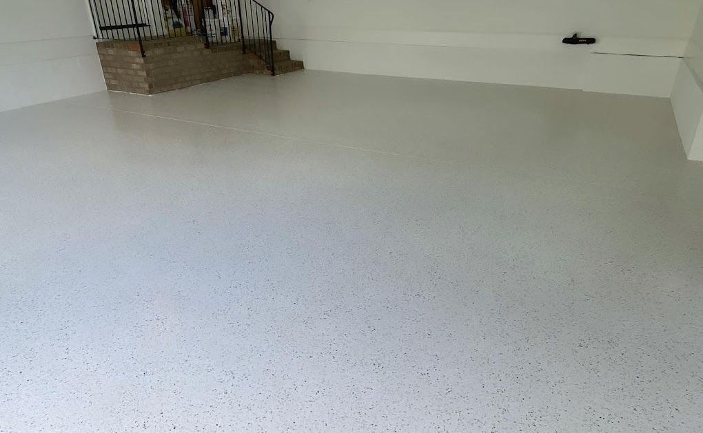 a white garage floor with a staircase in the background .