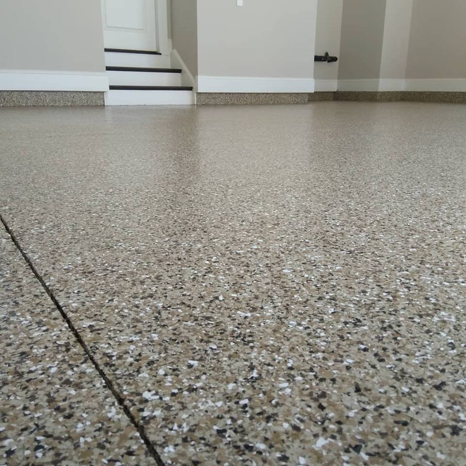 a garage floor with a staircase in the background