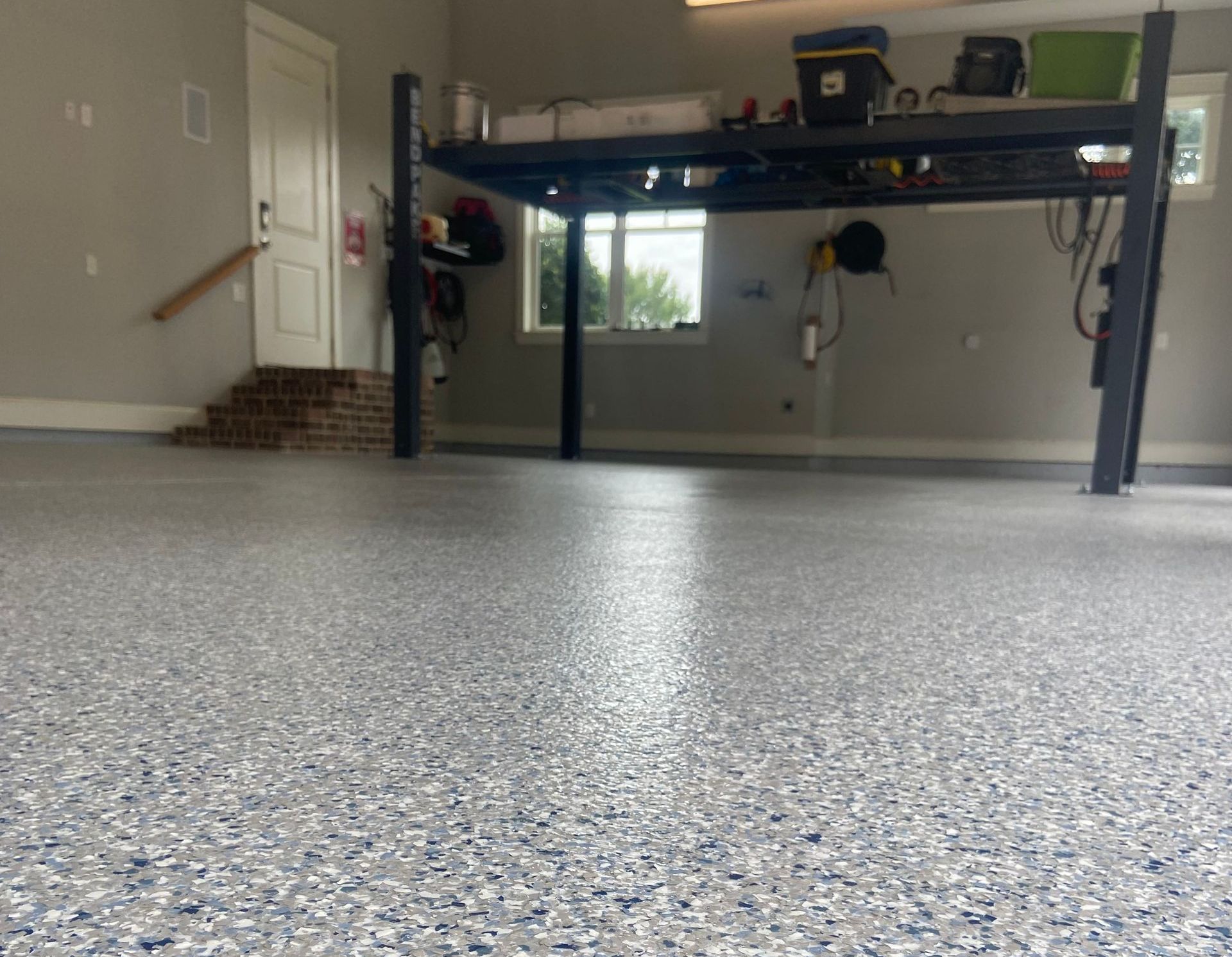 a garage with a concrete floor and a bunk bed .