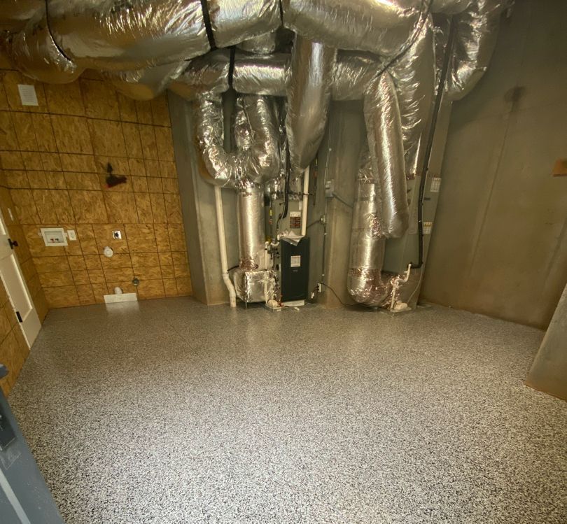 a room with a lot of pipes hanging from the ceiling