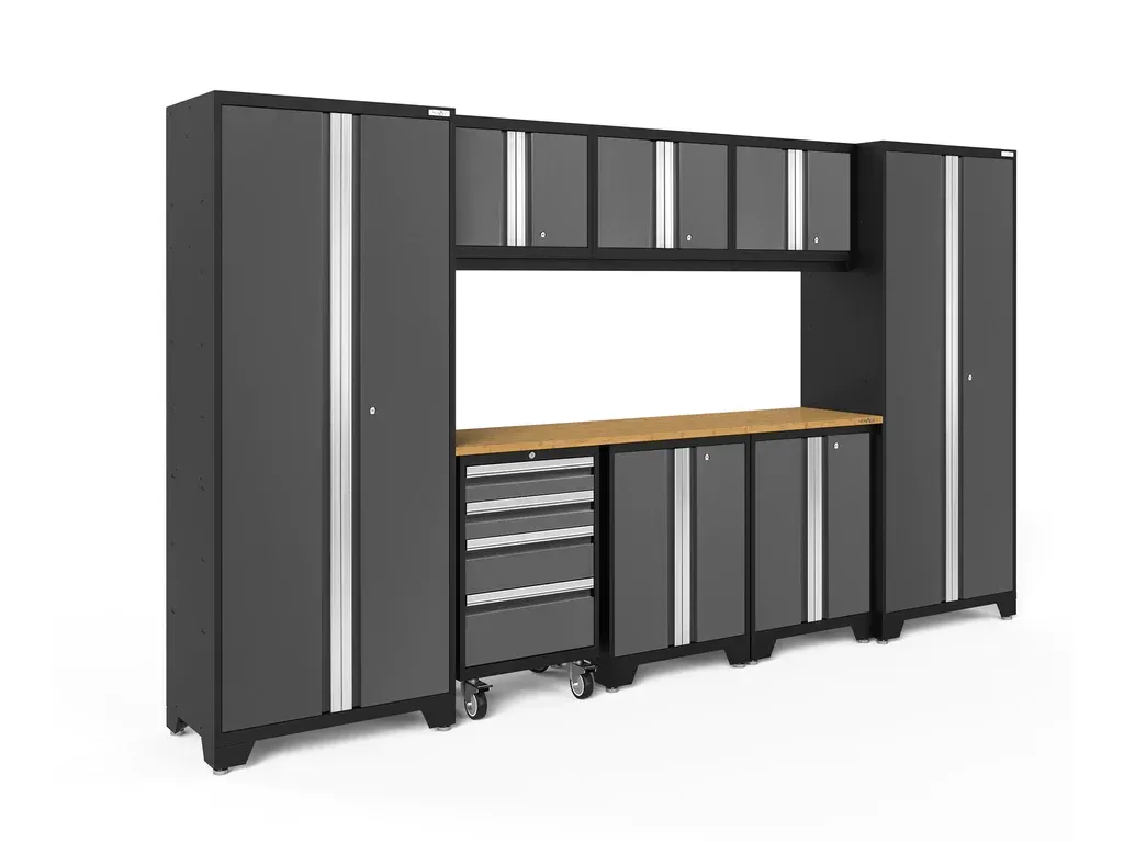a garage cabinet set with a wooden counter top and drawers .