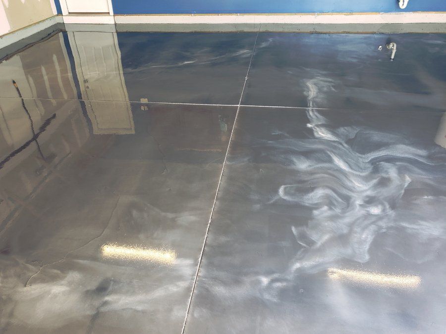 a close up of a shiny metallic floor in a garage .