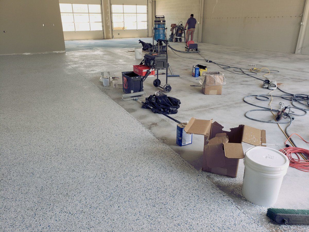 a large room with a carpeted floor and boxes on the floor .