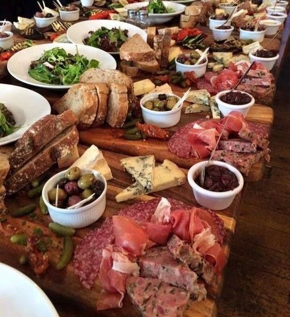 A Table Filled With Plates of Food and Bowls of Sauces — The Larder Byron Bay in Byron Bay, NSW