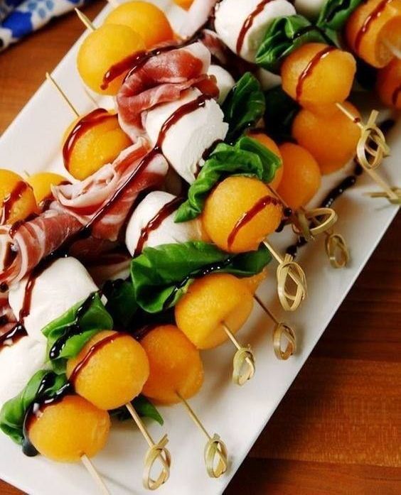 A White Plate Topped With Skewers of Fruit and Meat — The Larder Byron Bay in Byron Bay, NSW