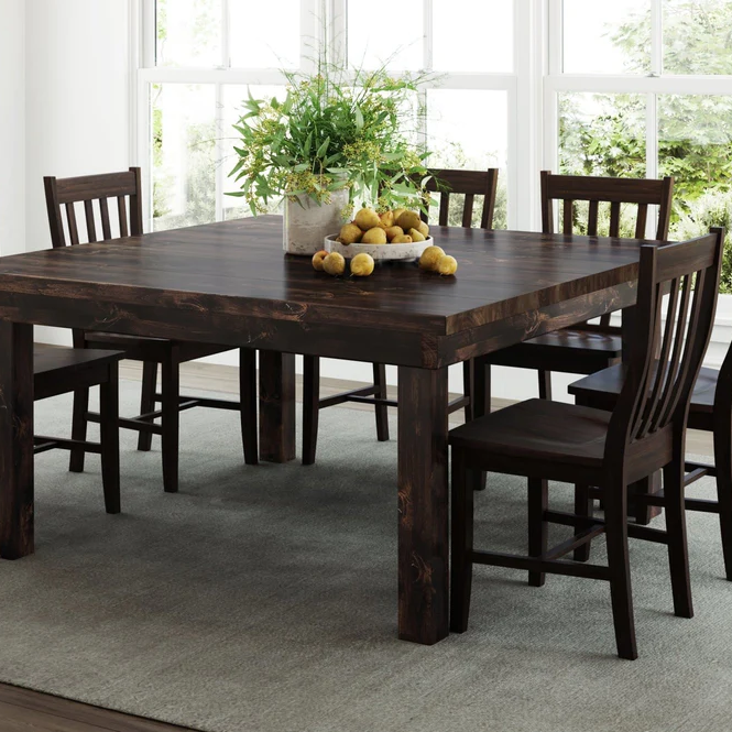 A dining room table with a bowl of lemons on it
