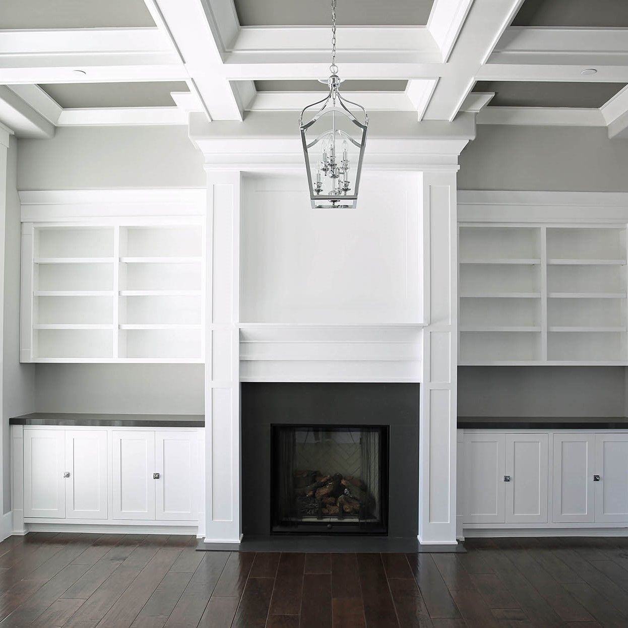 A living room with white cabinets and a fireplace