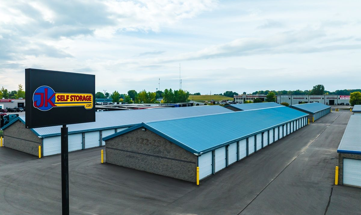 Driving past a JK Self Storage sign at a secure, gated facility.