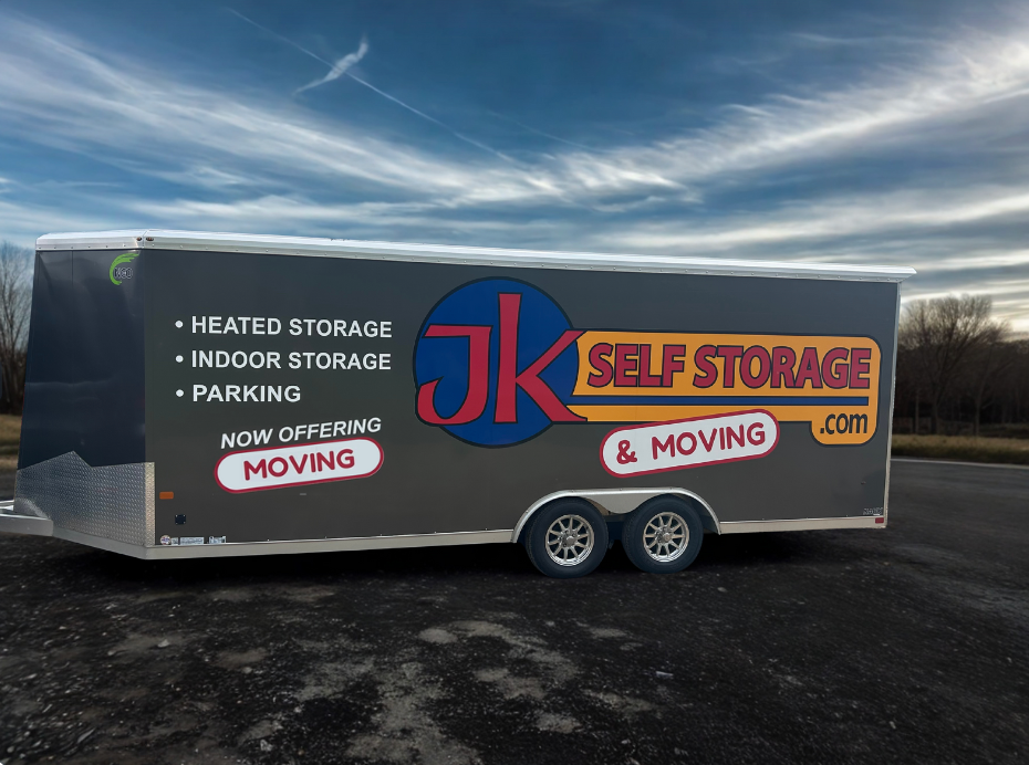 Trailer for JK Self Storage & Moving, with “heated storage,” “indoor storage,” and “parking” informational decals.