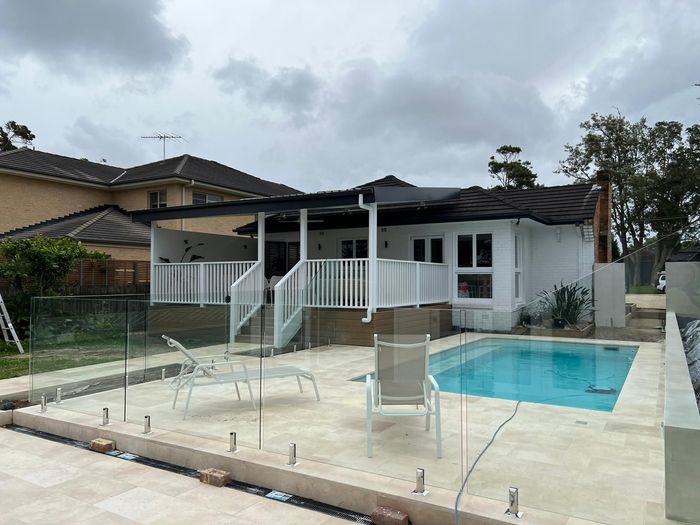 Glass fencing and limestone tiles for pool