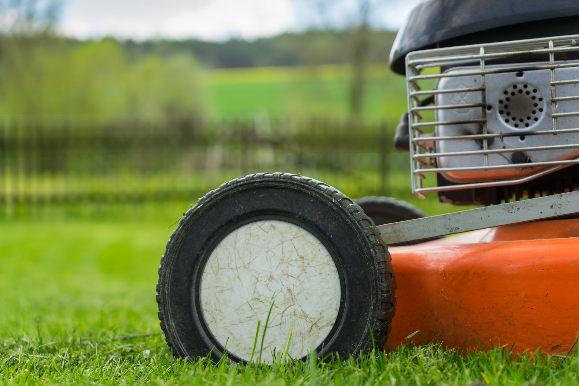 Detailing wheels and engine, representing the quality of a new lawn mower effectively.