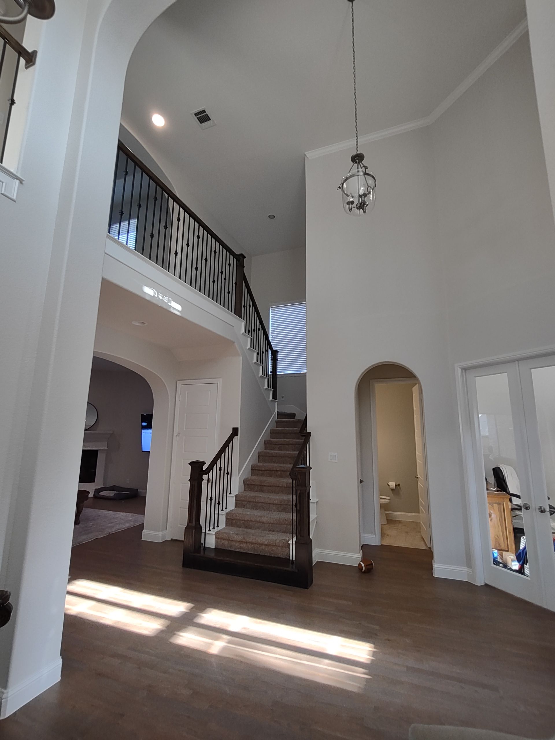 A large room with stairs leading up to the second floor