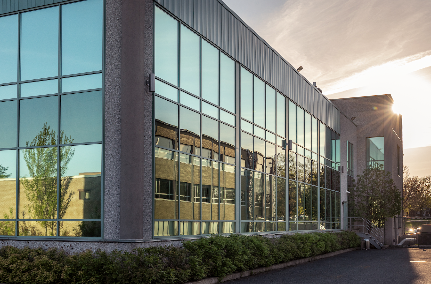 A large building with a lot of windows and a bicycle parked in front of it