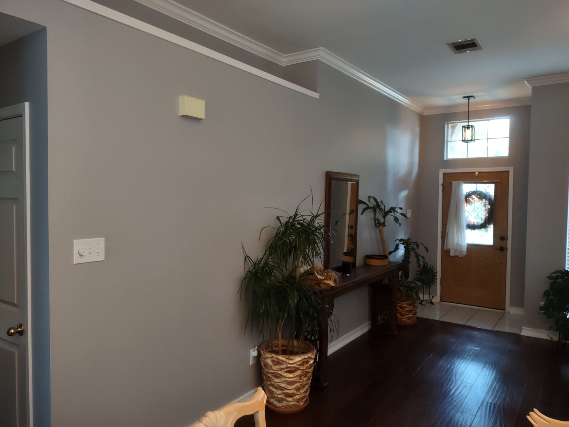 A hallway in a house with a table and a mirror