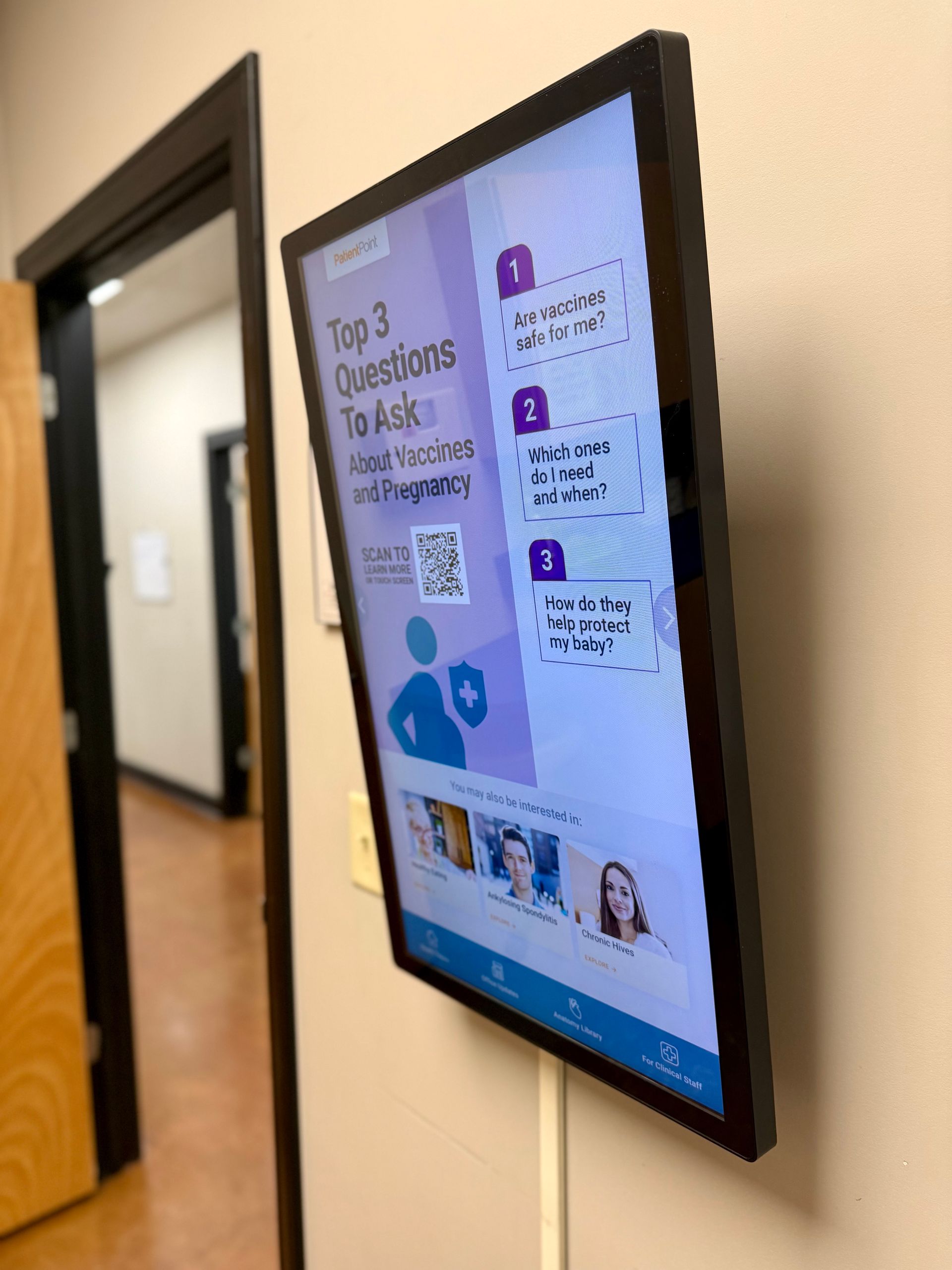 A wall-mounted digital screen displays