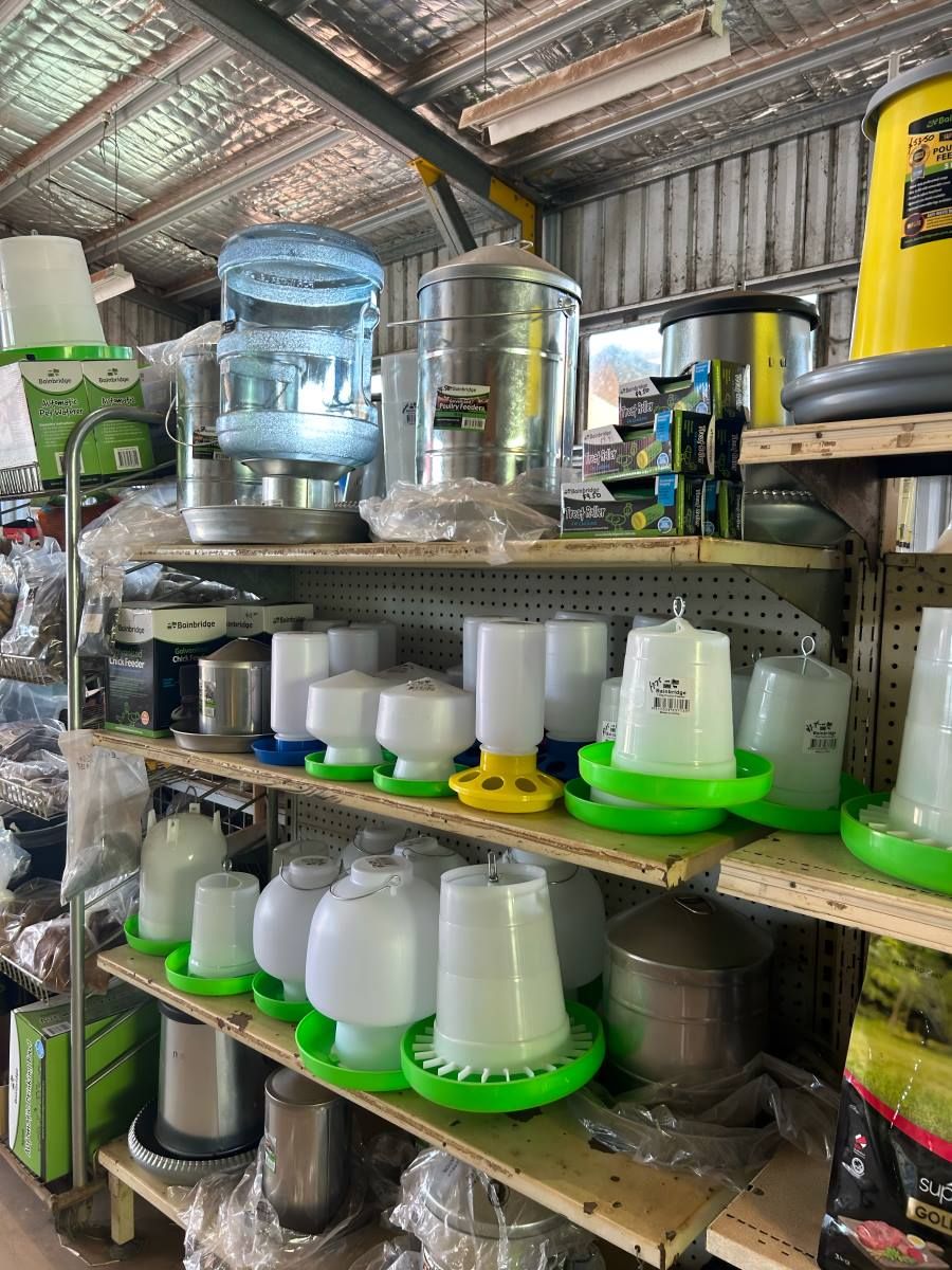 A Store Filled With Lots of Chicken Feeders and Water Bottles — Barnyard Stockfeed, Pet, Garden and Florist in Childers, QLD