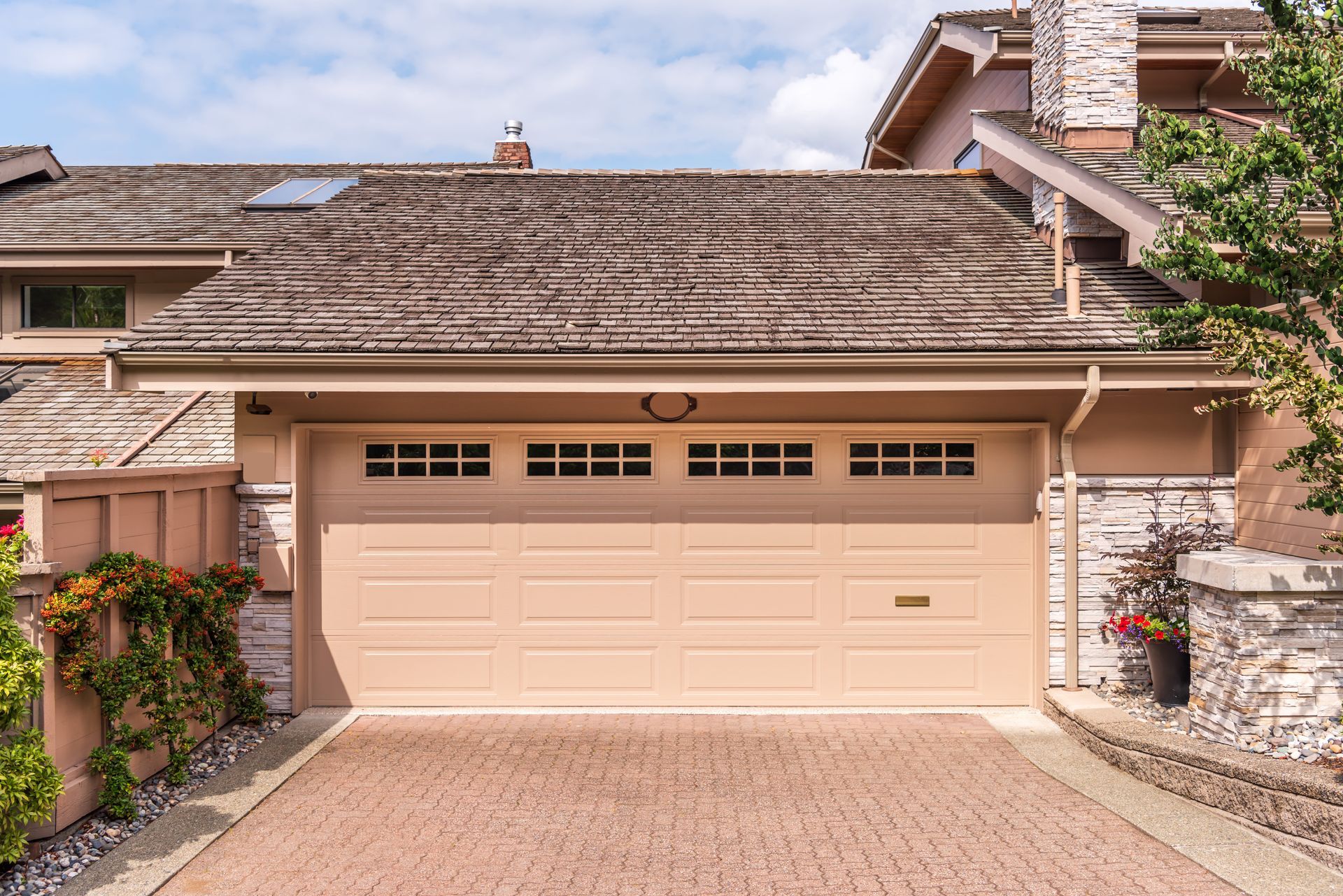 The exterior of a luxury residential home, possibly in Vancouver, Canada, featuring a large, beige p