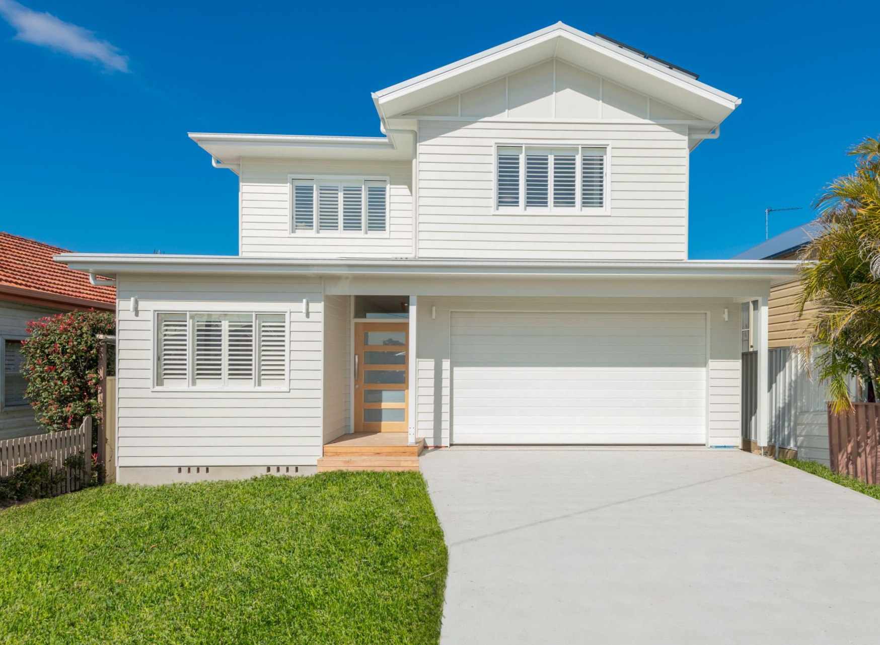 White two-story house with a garage and a driveway, on a sunny day — Indie Living In Hunter Valley, NSW