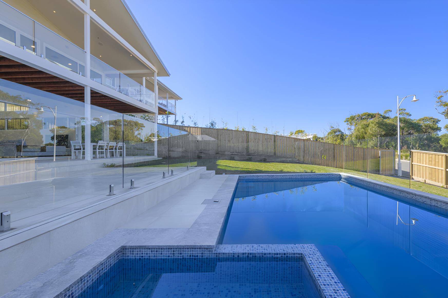 There is a Large Swimming Pool in the Backyard of a House — Indie Living In Bennetts Green, NSW