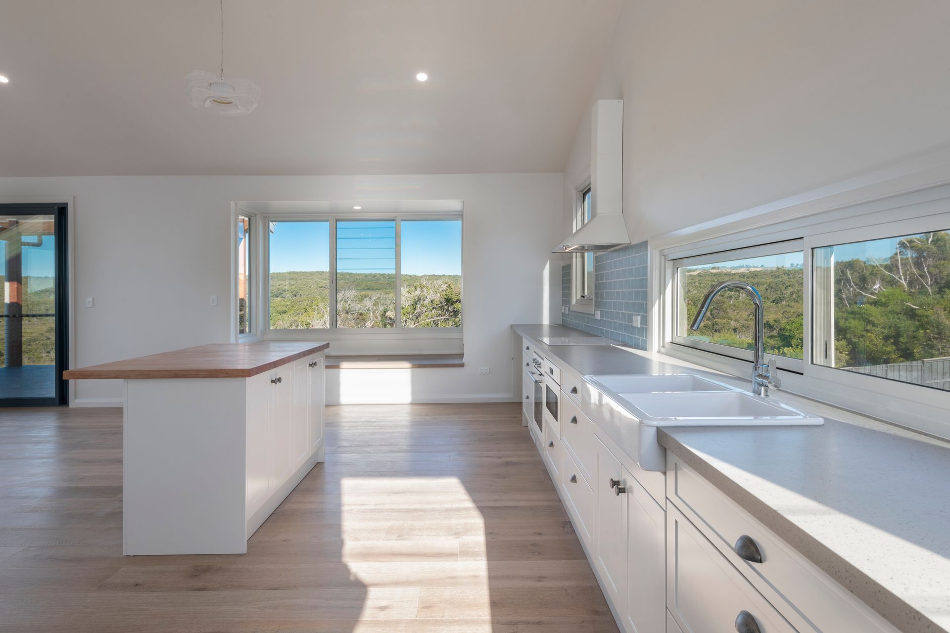 Modern White Kitchen With Island, and Large Windows Overlooking a Scenic View — Indie Living In Lake Macquarie, NSW