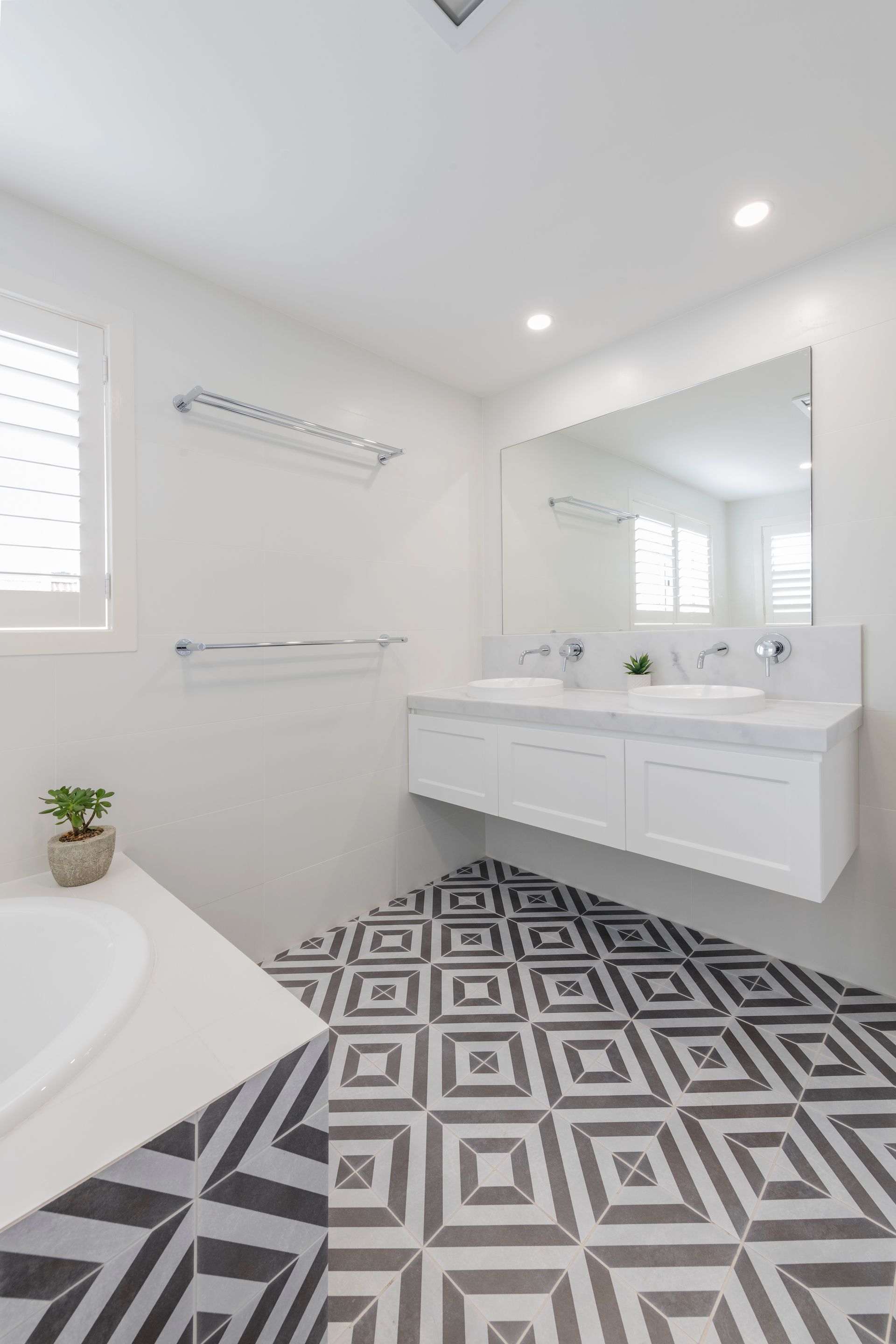 Modern white bathroom with patterned black and gray tile — Indie Living In Lake Macquarie, NSW