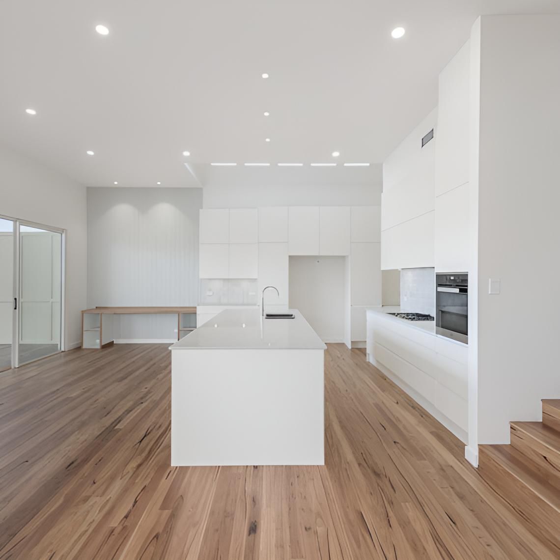 A Kitchen With White Cabinets and Wooden Floors — Indie Living In Bennetts Green, NSW
