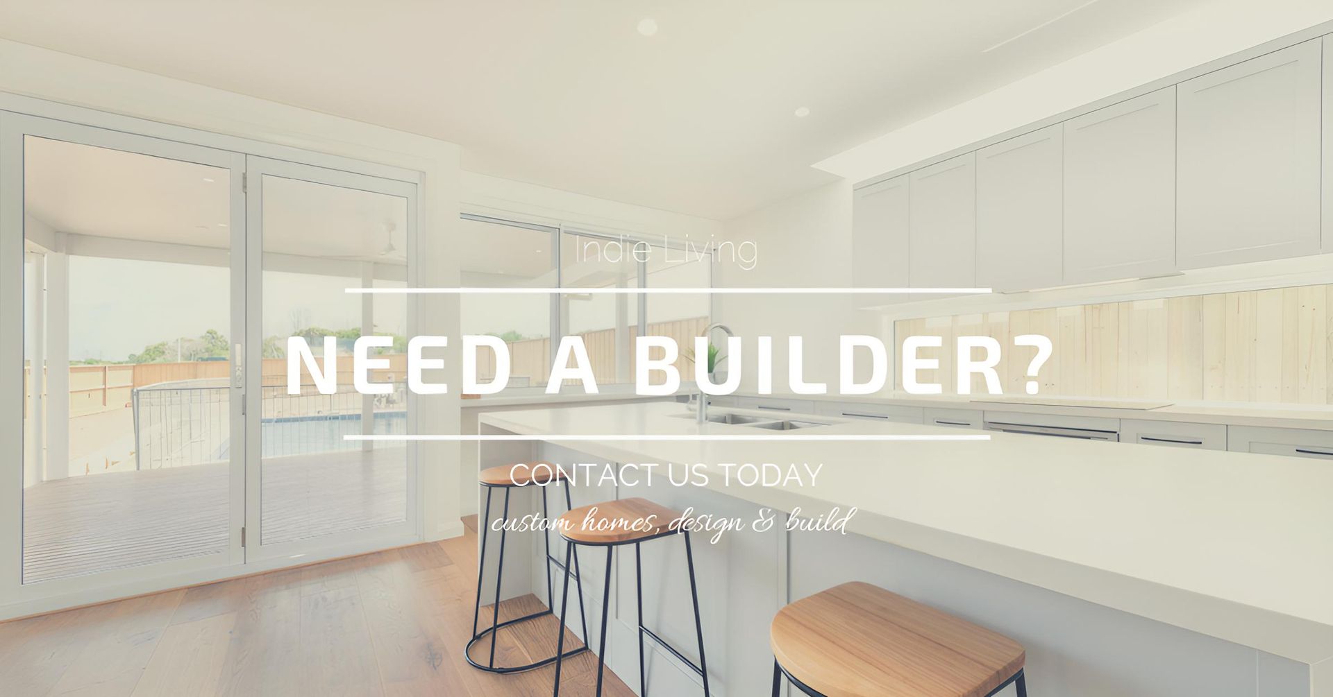 A kitchen with a bar and stools and the words `` need a builder ? '' — Indie Living In Bennetts Green, NSW