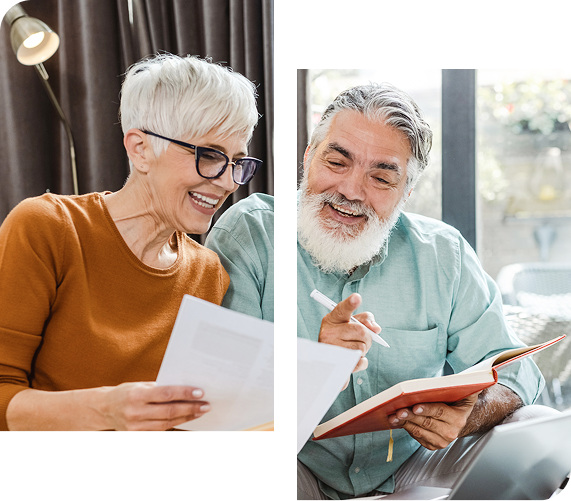 Two smiling people, one reading papers, the other writing in a notebook, indoors.