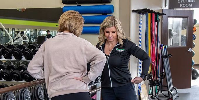 Dr. Tara Jaeger explaining an exercise to a patient.