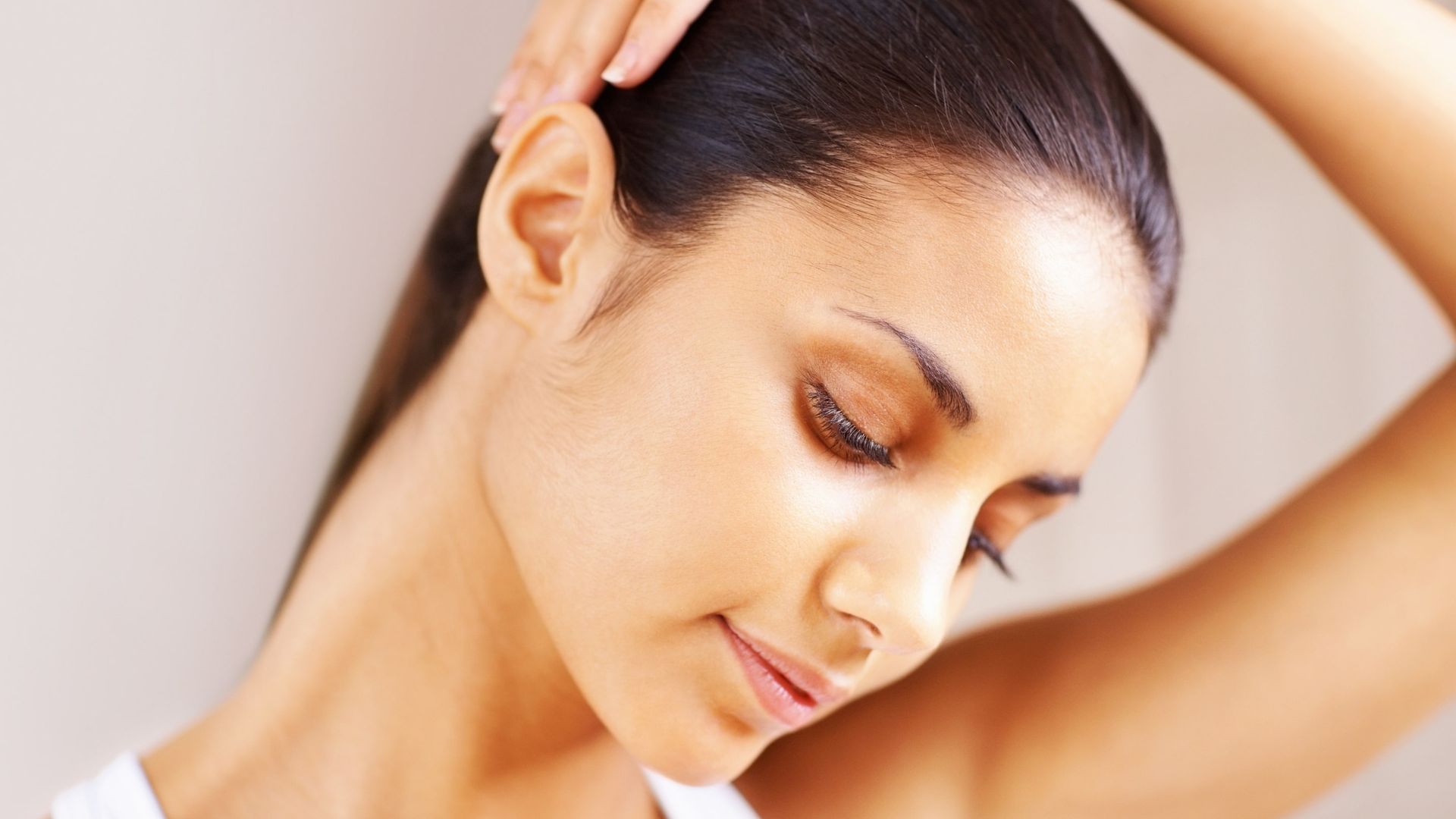 A woman doing neck stretches.