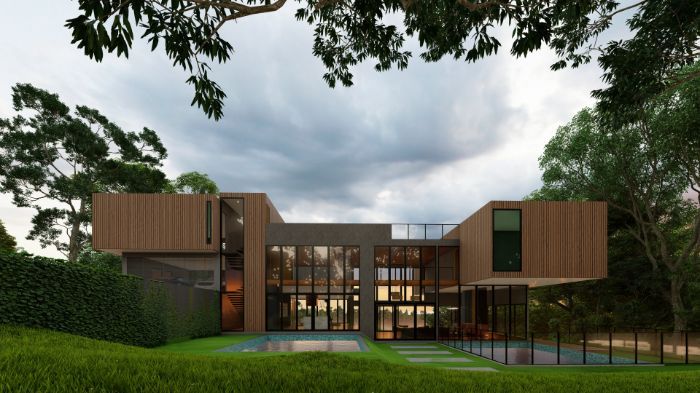 A Large House With a Lot of Windows is Surrounded by Trees — Omni Builders In Bungalow, QLD