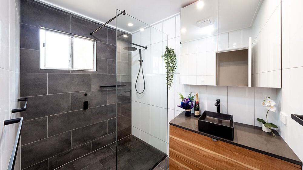 A Bathroom With a Walk in Shower and a Sink — Omni Builders In Bungalow, QLD