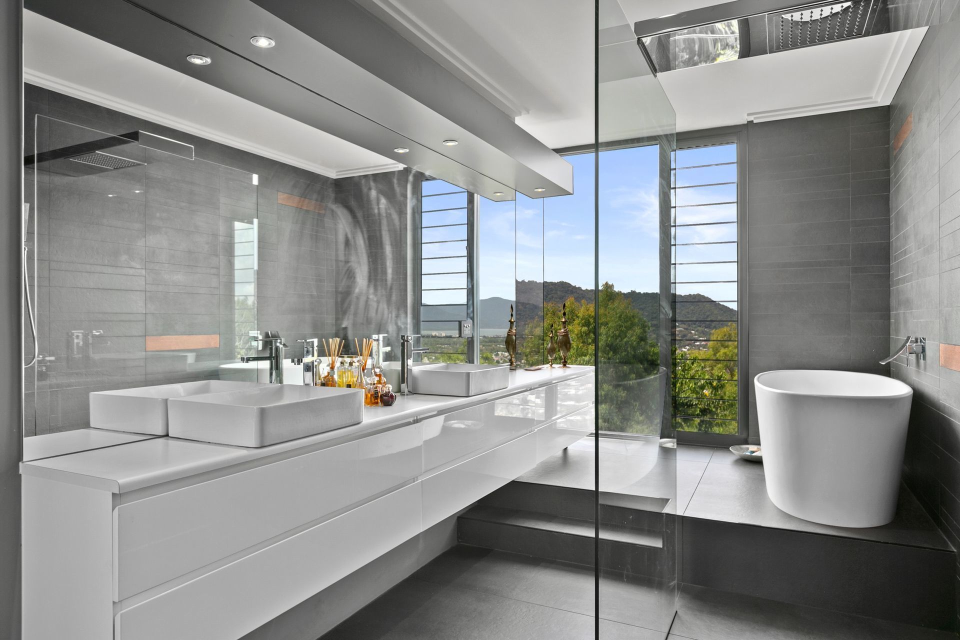 A Bathroom with Two Sinks, a Tub and A Large Window — Omni Builders In Redlynch, QLD