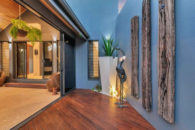 A Wooden Deck With a Statue of a Bird on It — Omni Builders In Bungalow, QLD