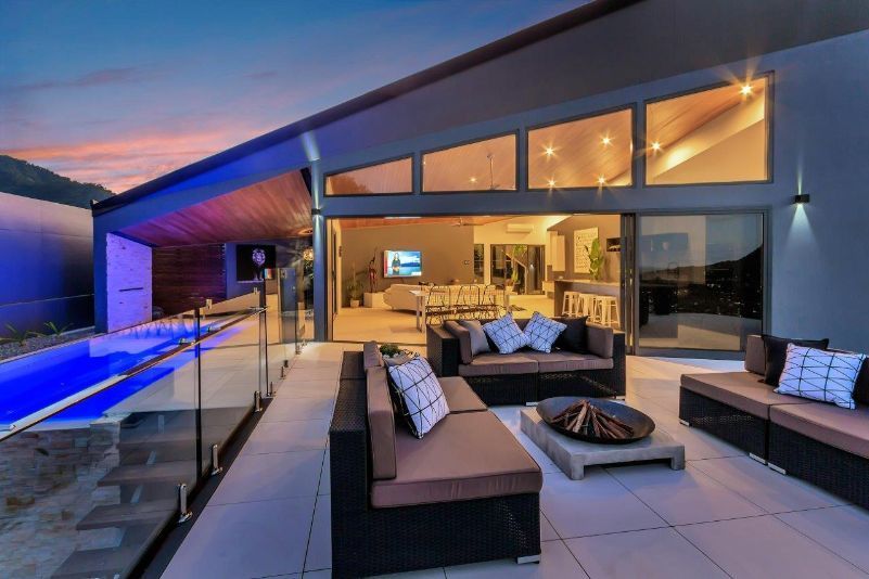There is a Large Swimming Pool in the Backyard of a House — Omni Builders In Bungalow, QLD