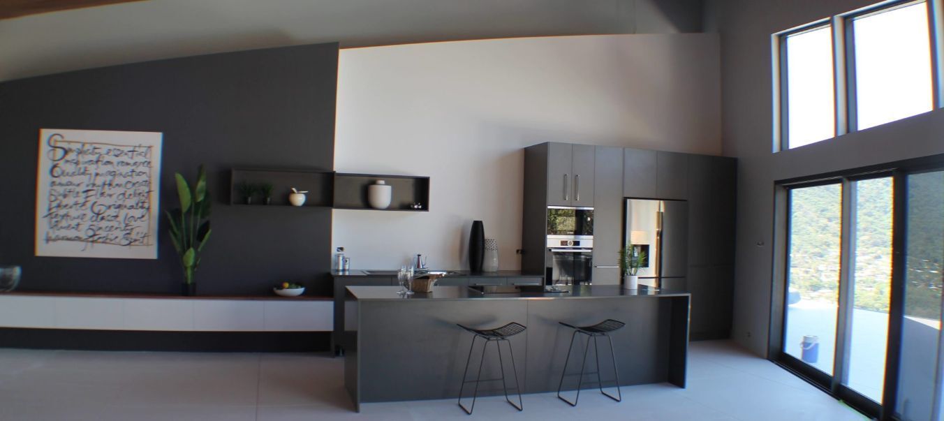 A Kitchen With a Large Island in the Middle of the Room — Omni Builders In Bungalow, QLD