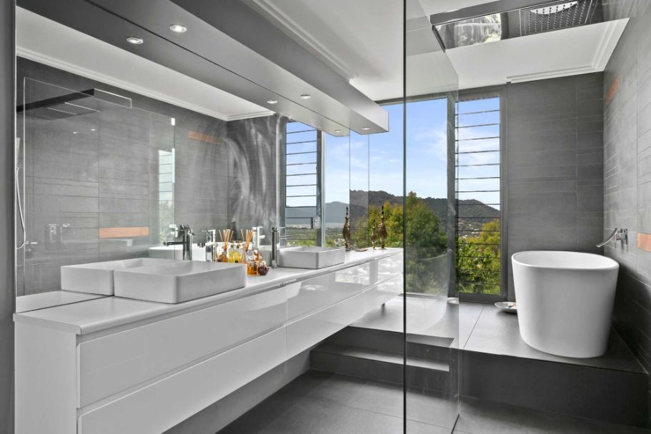 A Bathroom With Two Sinks , a Tub and a Walk in Shower — Omni Builders In Bungalow, QLD