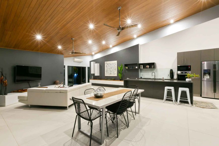 There is a Dining Table and Chairs in the Middle of the Room — Omni Builders In Bungalow, QLD