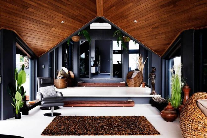 A Living Room With a Vaulted Ceiling and a Rug — Omni Builders In Bungalow, QLD