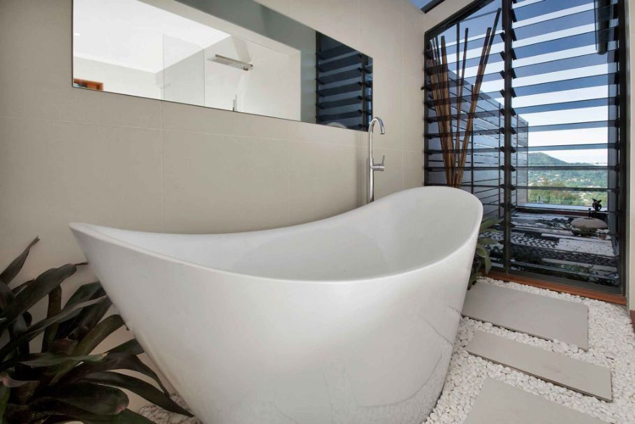 There is a Bathtub in the Bathroom Next to a Window — Omni Builders In Bungalow, QLD