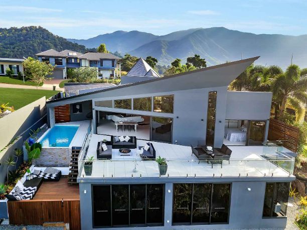 An Aerial View of a House With a Pool and Mountains in the Background — Omni Builders In Bungalow, QLD