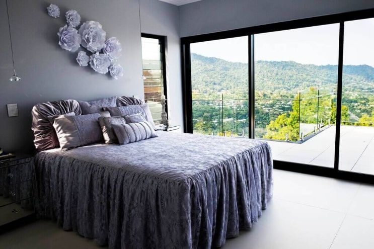 A Bedroom With a Large Bed , Sliding Glass Doors and a View of the Mountains — Omni Builders In Bungalow, QLD